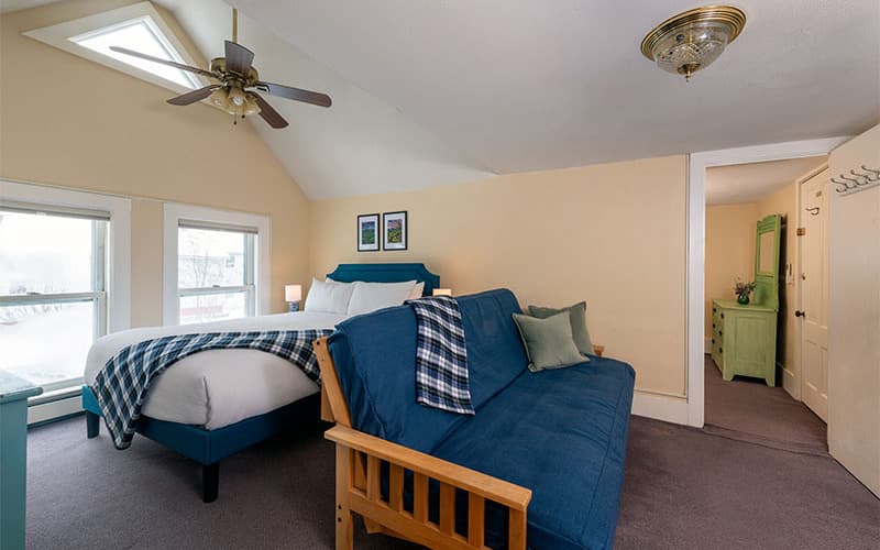Queen bed and futon in Suite 4